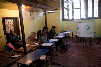 Election officers sit inside an empty polling station during the second phase of India's general elections, in Srinagar, Indian controlled Kashmir, Thursday, April 18, 2019. Kashmiri separatist leaders who challenge India's sovereignty over the disputed region have called for a boycott of the vote. Most polling stations in Srinagar and Budgam areas of Kashmir looked deserted in the morning with more armed police, paramilitary soldiers and election staff present than voters. (AP Photo/ Dar Yasin)