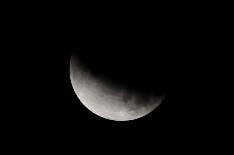The earth's umbra partially shadowed the moon during a partial lunar eclipse in Kolkata, India. AP Photo/Bikas Das