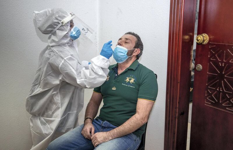 Abu Dhabi, United Arab Emirates, June 22, 2020.   STORY BRIEF: Police patrols knocking on doors offering free Covid-19 tests to residents in buildings in AD downtown, Al Bakra Street area.--  Building resident Ziad Marchi-42 from Lebanon gets a swab test.Victor Besa  / The NationalSection:  NAReporter:  Haneen Dajani