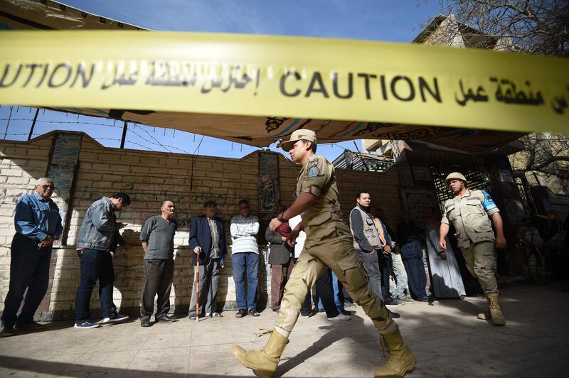 Egyptian army soldiers patrol as voters queue up outside a polling station before the start of the first day of the 2018 presidential elections, in al-Haram neighbourhood in the capital Cairo's southwestern Giza district on March 26, 2018. Mohamed El-Shahed / AFP