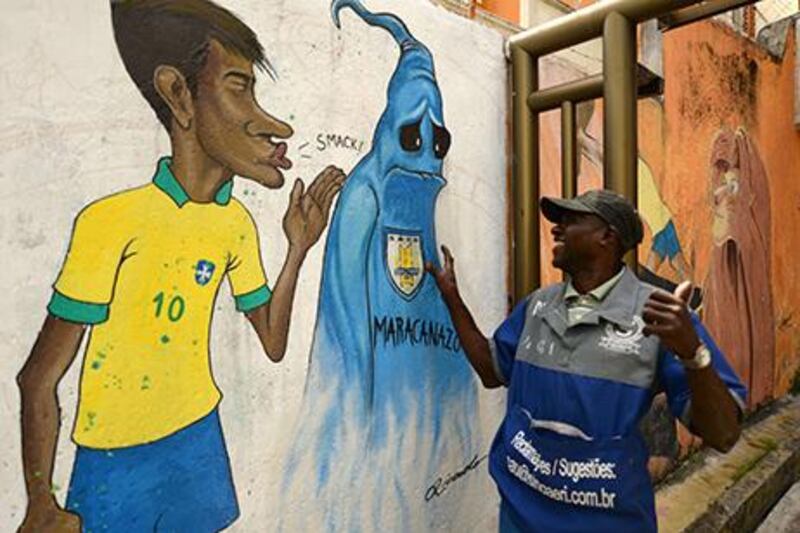 A peddler smiles as he sees a graffiti depicting Brazil's footballer Neymar kissing goodbye the ghost of the "Maracanazo" (the defeat of Brazil by the winning Uruguayan team in the 1960 world cup) in a suburb of Rio de Janeiro. Vanderlei Almeida / AFP