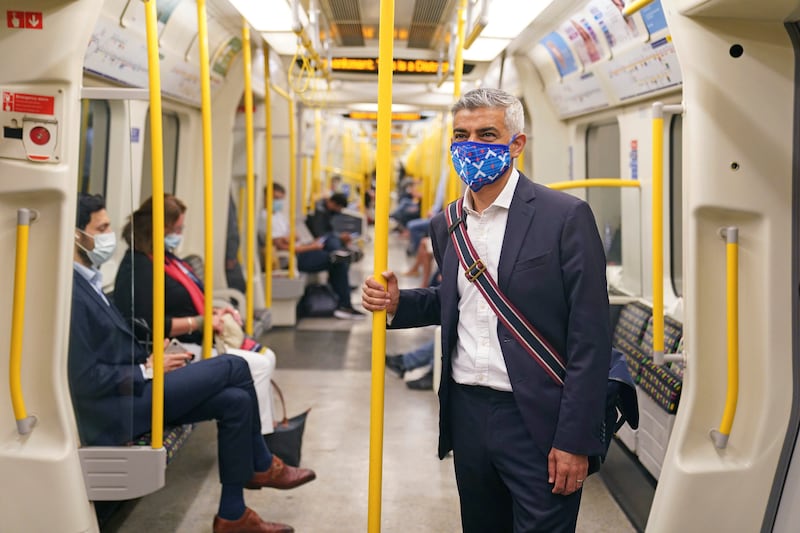 Mayor of London Sadiq Khan wears a mask as he rides on a London Underground train.  Mr Khan has asked Transport for London to enforce mask-wearing on buses and trains, even after legal restrictions in England are lifted on July 19..