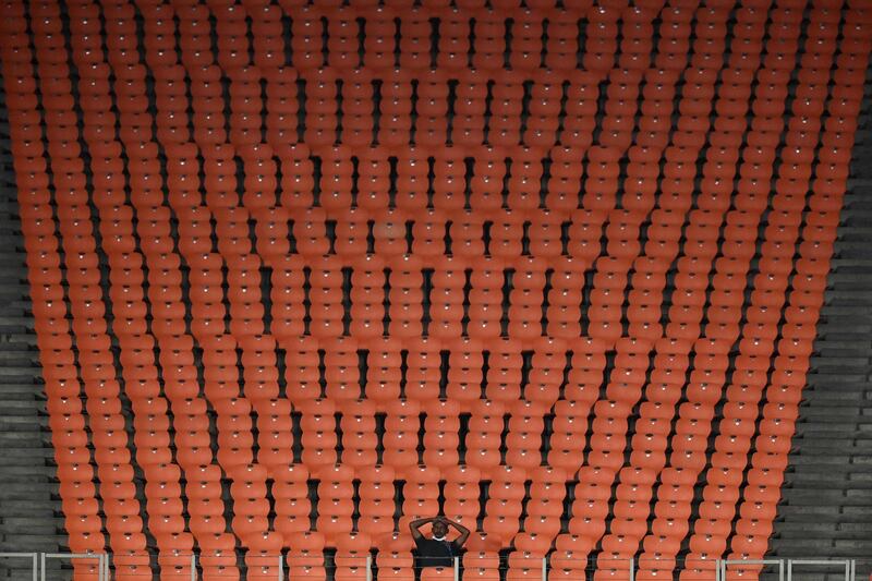 A single spectator sits in an empty stand, due to Covid-19 restrictions, as he watches the third Twenty20 international cricket match between India and England at the Narendra Modi Stadium in Motera, India. AFP