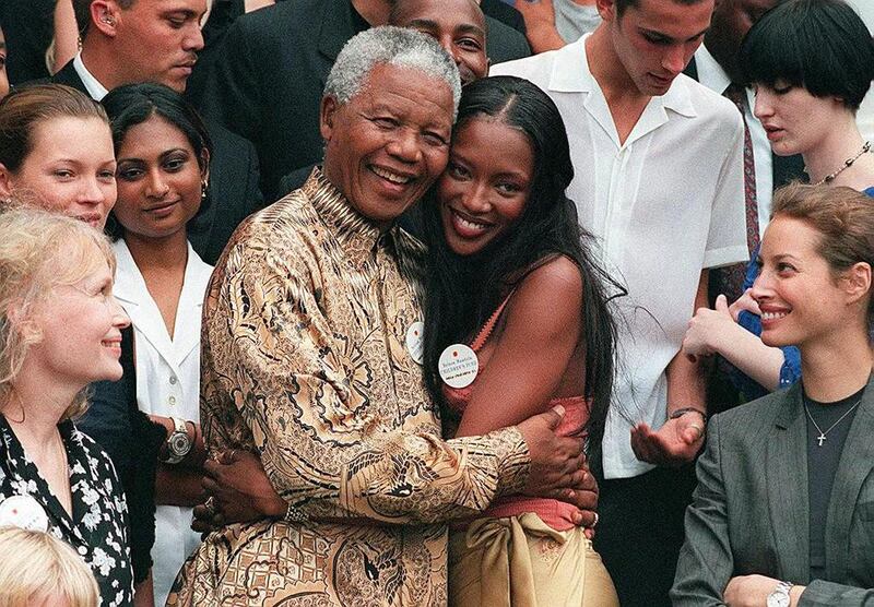 Nelson Mandela embraces British model Naomi Campbell in front of US actress Mia Farrow, British model Kate Moss and US model Christy Turlingto, at Genadendal, his Cape Town home. Anna Zieminski / AFP Photo 