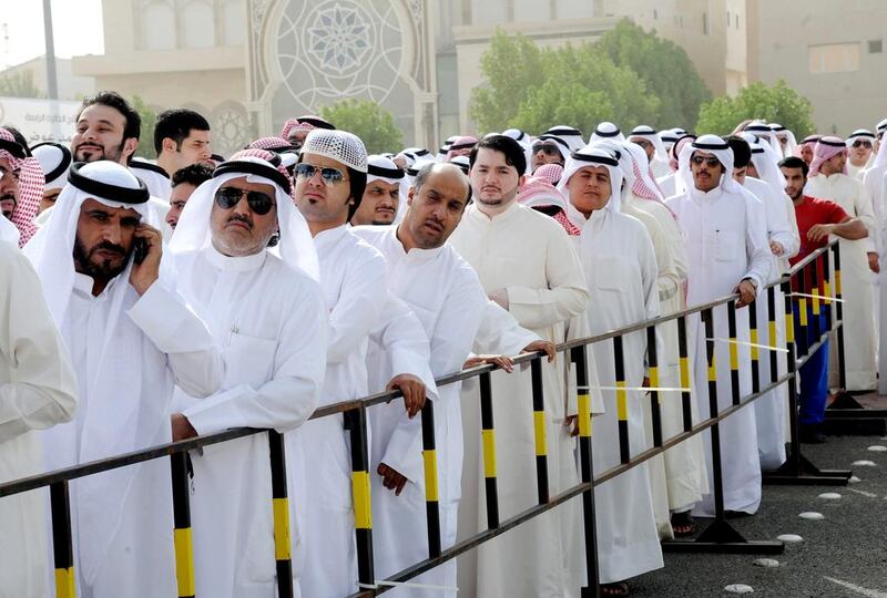 Kuwaitis line up to vote in their July parliamentary elections. Kuwait’s welfare system provides citizens with grants and loans for education, health, housing, and subsidies on electricity and fuel. Raed Qutena / EPA



