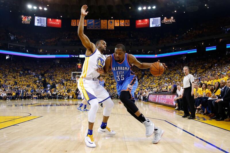 Kevin Durant #35 of the Oklahoma City Thunder drives with the ball against Andre Iguodala #9 of the Golden State Warriors in Game Seven of the Western Conference Finals during the 2016 NBA Playoffs at ORACLE Arena on May 30, 2016 in Oakland, California. Ezra Shaw/Getty Images/AFP