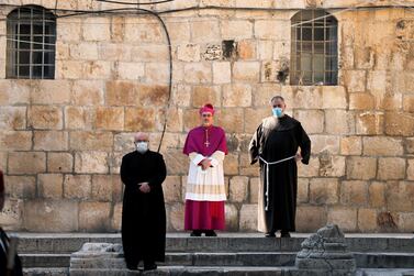 Archbishop Pierbattista Pizzaballa, apostolic administrator of the Latin Patriarchate of Jerusalem, stands at the entrance to the Church of the Holy Sepulchre amid coronavirus restrictions in Jerusalem's Old City. Reuters