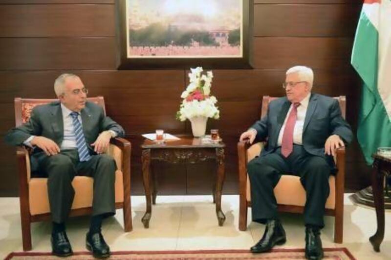 Palestinian President Mahmoud Abbas (right) accepts the resignation of Prime Minister Salam Fayyad during an April 13 meeting in Ramallah.