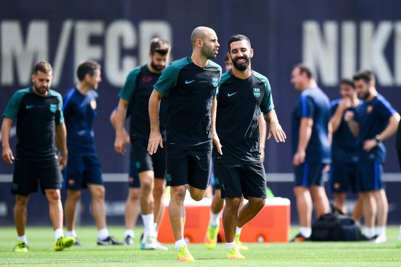 Javier Mascherano, left, and Ardan Turan. David Ramos / Getty Images