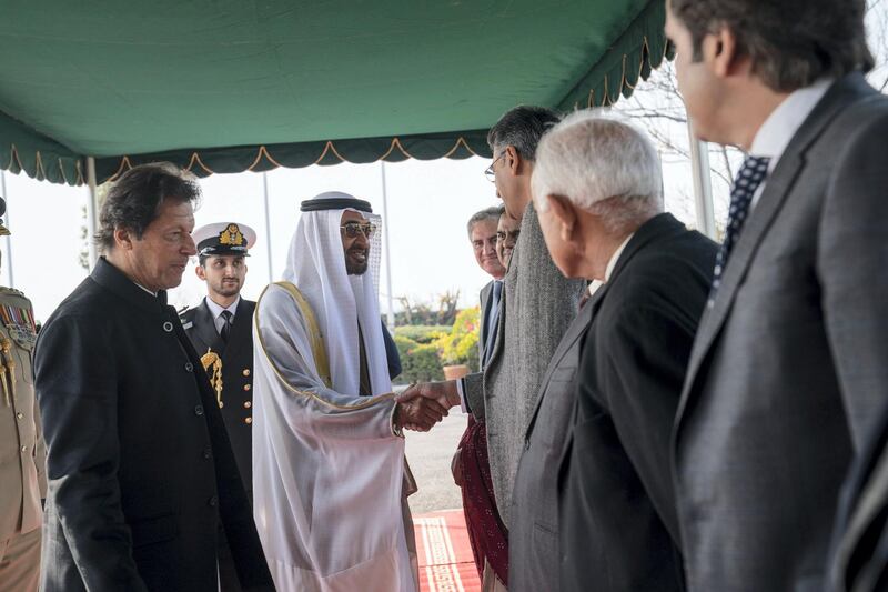 ISLAMABAD, PAKISTAN - January 06, 2019: HH Sheikh Mohamed bin Zayed Al Nahyan, Crown Prince of Abu Dhabi and Deputy Supreme Commander of the UAE Armed Forces (2nd L), greets a guest during a reception at the Prime Minister's residence. Seen with  HE Imran Khan, Prime Minister of Pakistan (L)

(  Mohammed Al Hammadi / Ministry of Presidential Affairs )
---