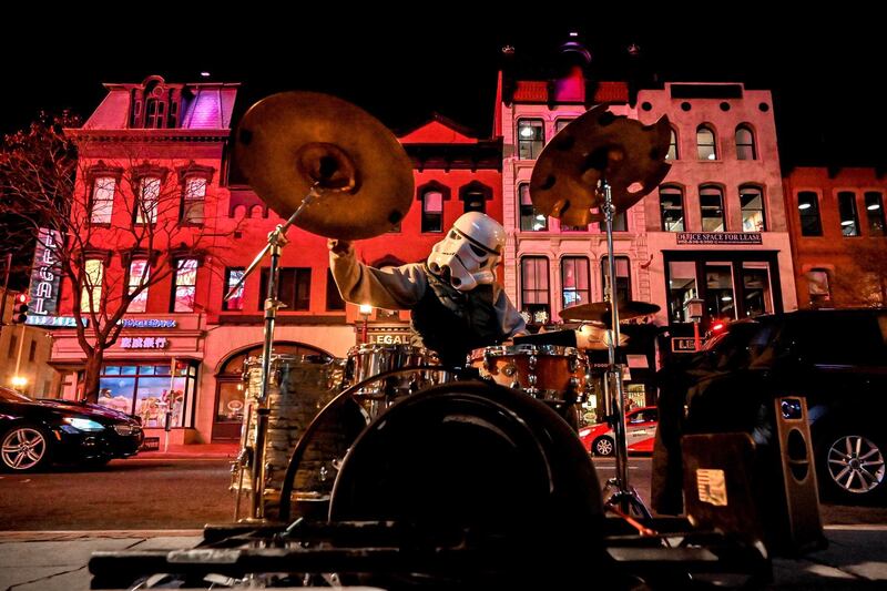 A street musician wearing a Star Wars Stormtrooper helmet plays drums at the Gallery Place in Washington, DC, USA. EPA