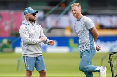 England head coach Brendon McCullum, left, and Ben Stokes stretches during a nets session at Trent Bridge Cricket Ground, Nottingham, England, Thursday June 9, 2022 one day ahead of the 2nd test match between England and New Zealand.  (Mike Egerton / PA via AP)