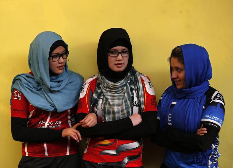 Masooma Alizada, left, Zahra Alizada, centre, and Frozan Rasooli, members of Afghanistan’s Women’s National Cycling Team talk with each other before training. Mohammad Ismail / Reuters