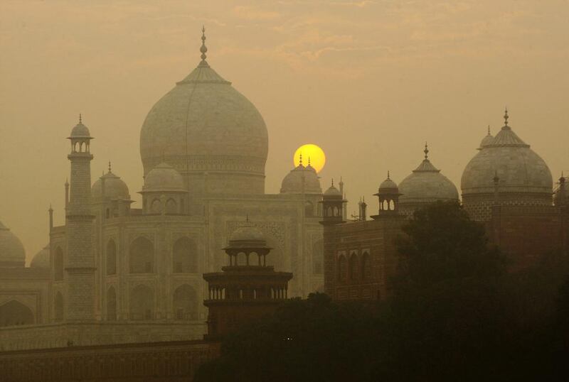 The sun rising over the Taj Mahal in Agra, India. Archaeological experts say insects proliferating from a polluted river near the Taj Mahal are marring the intricate marble inlay work by leaving greenish black patches of waste on its walls. Gurinder Osan/AP Photo