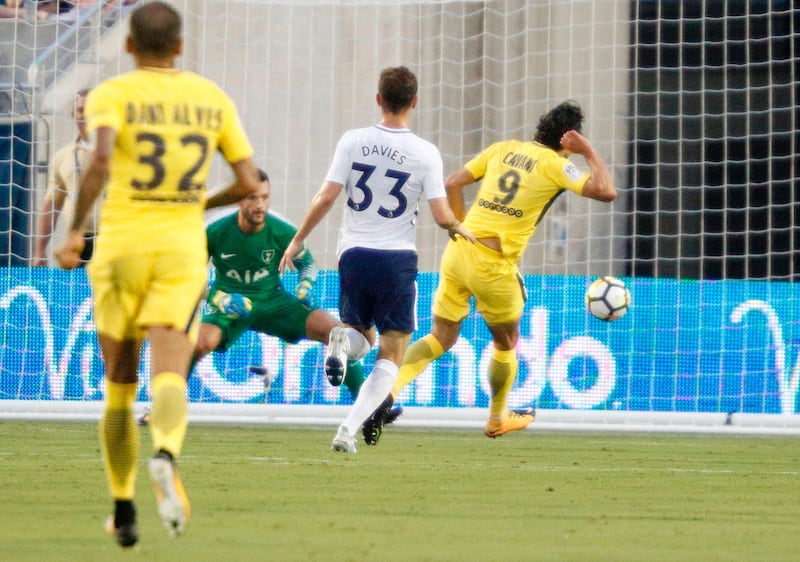 Edinson Cavani, right, of Paris Saint-Germain kicks a goal past keeper Hugo Lloris, second from left, of Tottenham Hotspur during their friendly in Orlando, Florida. Gregg Newton / AFP