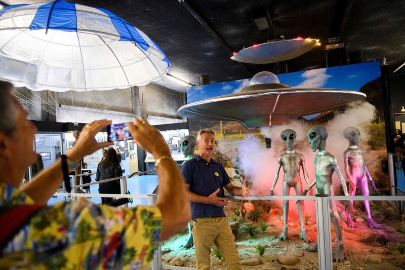 People take pictures of exhibits at the International UFO Museum and Research Centre. AFP