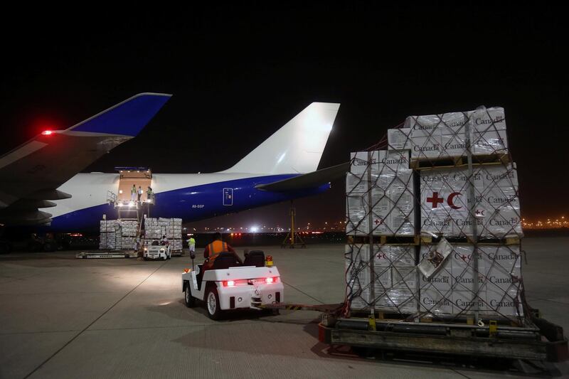Workers load aid onto an airplane to be delivered to Rohingya refugees residing in Bangladesh, in coordination between UNHCR and United Arab Emirates, at Dubai airport, UAE, October 11, 2017. REUTERS/Satish Kumar