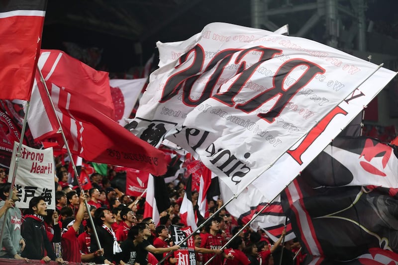 Supporters of the Urawa Reds football team sing and wave banners before the start of the second leg. AFP