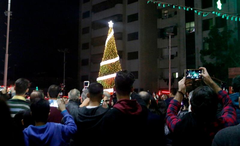 Palestinian Christians attend a Christmas tree lighting celebration in Gaza City, Tuesday, Dec. 3, 2019. (AP Photo/Hatem Moussa)