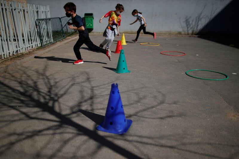 Schoolchildren exercise in the playground at the private primary school Jeanne D'Arc in Saint-Maur-des-Fosses, near Paris. Reuters