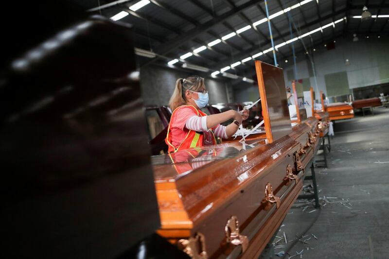 An employee of Platinum Casket Company works on the production of new coffins in Los Reyes La Paz, Mexico. Reuters