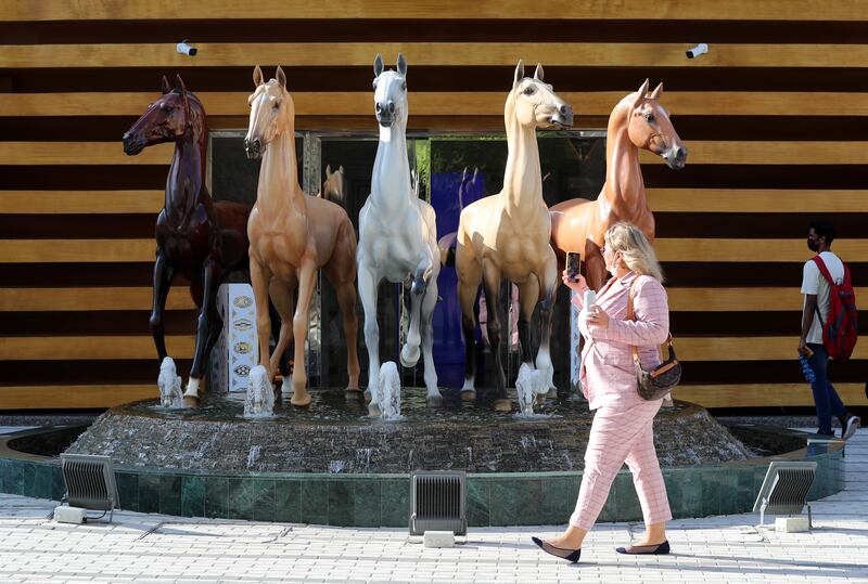 A visitor to the Turkmenistan pavilion takes pictures on the 10th day of Expo 2020 Dubai. Chris Whiteoak / The National