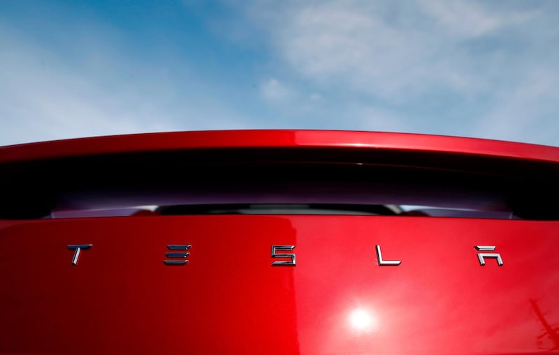 FILE - In this April 15, 2018 file photo, the sun shines off the rear deck of a roadster on a Tesla dealer's lot in the south Denver suburb of Littleton, Colo. Tesla has picked Austin, Texas, and Tulsa, Oklahoma, as finalists for its new U.S. assembly plant, a person briefed on the matter said Friday, May 15, 2020. (AP Photo/David Zalubowski, File)