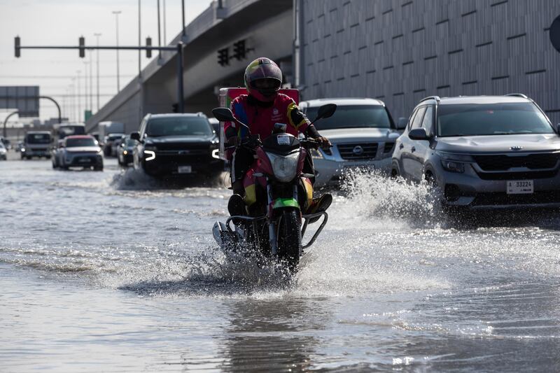 Morning commuters plough through flooded streets in Al Quoz. Antonie Robertson / The National