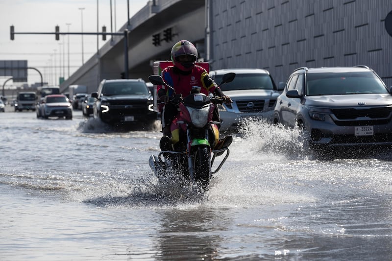 Morning commuters plough through flooded streets in Al Quoz. Antonie Robertson / The National