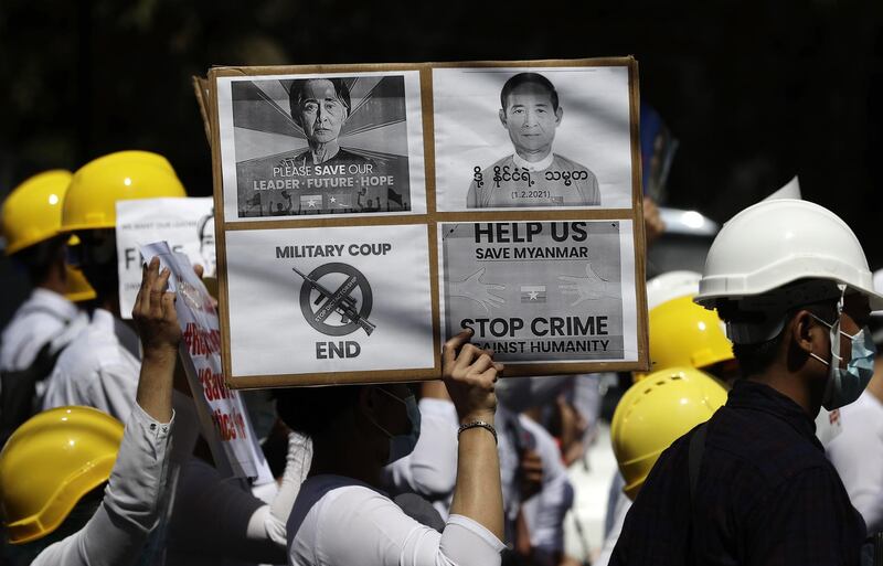 School teachers hold placards calling for the release of detained Myanmar State Counselor Aung San Suu Kyi (L) and President Win Myint (R) during a protest against the military coup outside the Chinese Embassy in Yangon, Myanmar. EPA