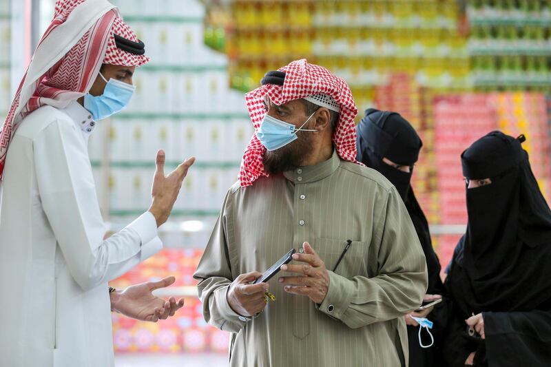 A man displays his details on his mobile phone using the Tawakkalna app, which was launched by Saudi authorities to track people infected with the coronavirus disease (COVID-19), as he enters the Al-Othaim market in Riyadh, Saudi Arabia February 22, 2021. Picture taken February 22, 2021. REUTERS/Ahmed Yosri
