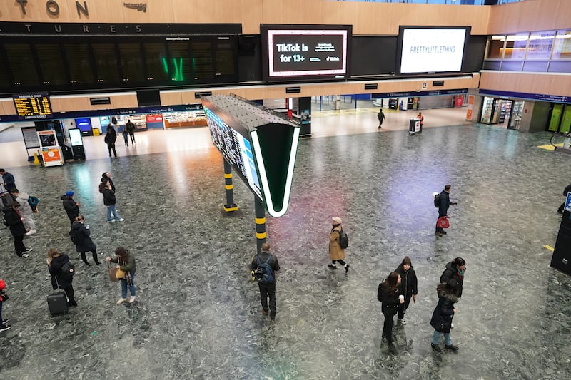 Passengers in an almost deserted Euston station during morning rush hour in London. PA