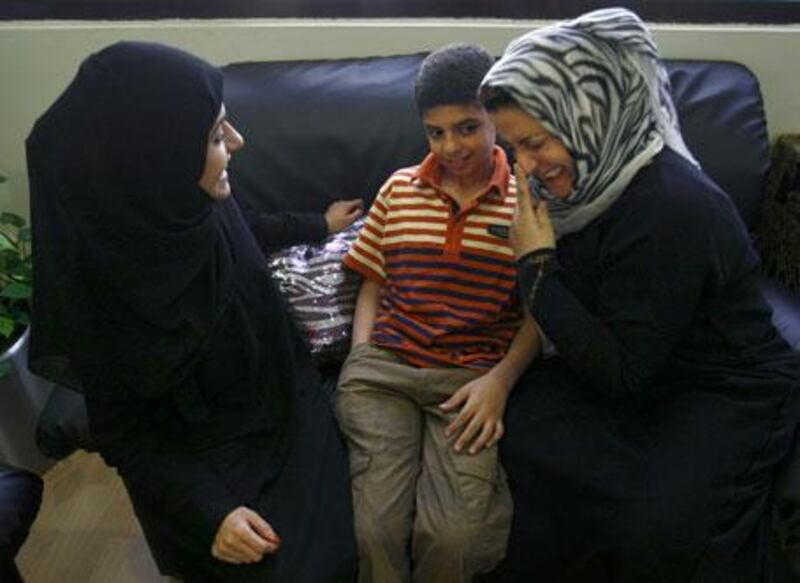 Al Anood al Abdool, a volunteer at the Friends of Cancer Patients Centre of Sharjah, chats to Mustafa Jabar, 11, who suffers from non-Hodgkin's lymphoma as well as hepatitis B and C, and his mother Nabela al Badri, who is also a volunteer at the centre, which has been treating her son for the past four years. Among other things, the volunteers make sure there is a friendly face and emotional support for patients and their families.