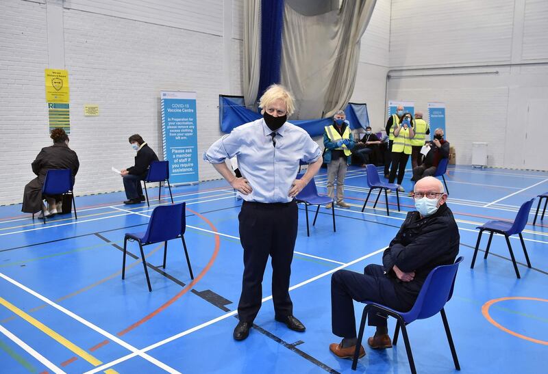 Boris Johnson speaks to members of the public waiting to receive a Covid-19 vaccine as he tours the Lakeland Forum Covid-19 vaccination centre in Enniskillen, Northern Ireland. AFP