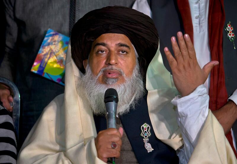 FILE - In this Sunday, Nov. 26, 2017 file photo, head of the Pakistani Tehreek-e-Labbaik party chief Khadim Hussain Rizvi gestures during a press conference in Islamabad, Pakistan. A Pakistani minister on Saturday, Dec. 1, 2018 says the detained Islamic clerics who disrupted daily life with rallies across Pakistan following the acquittal of a Christian woman in a blasphemy case will face treason and terrorism charges. (AP Photo/Anjum Naveed, File)