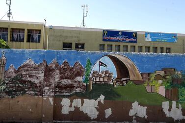 Graffiti is seen on the exterior walls of a closed government school in Amman. EPA