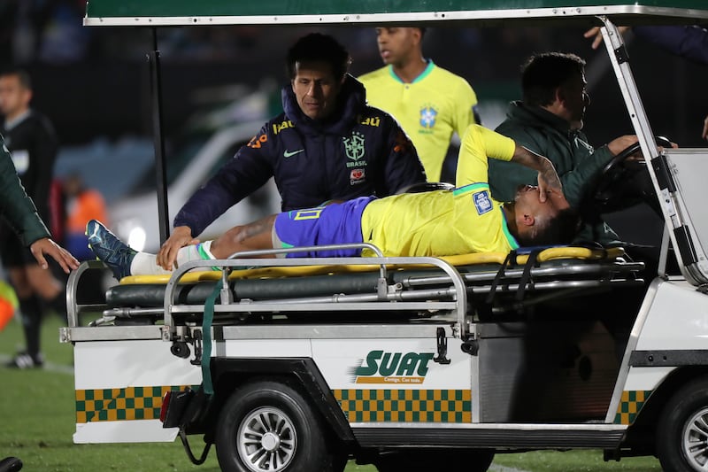 Neymar is assisted off the field after his injury. EPA