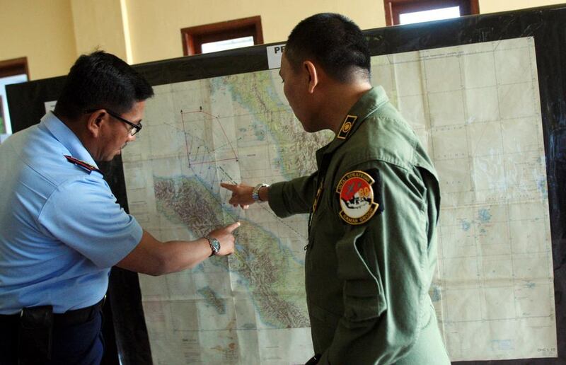 Indonesian air force officers check the map as they prepare for a search operation. Ded Sahputra / EPA March 12