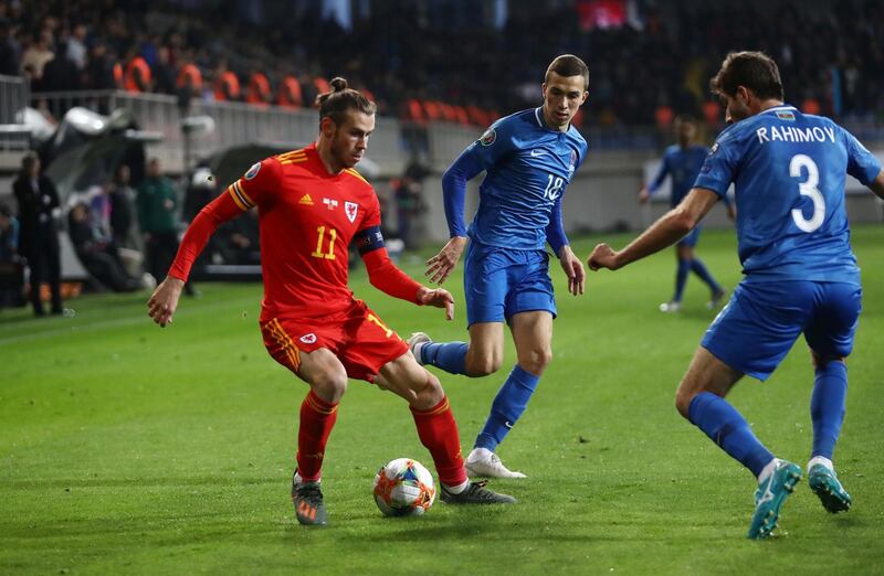 Wales's Gareth Bale in action against Azerbaijan's Shahriyar Rahimov and Anton Krivotsyuk. Reuters