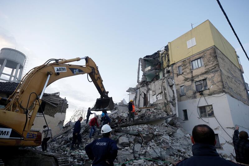 Emergency personnel work near a damaged building in Thumane, after an earthquake shook Albania. REUTERS