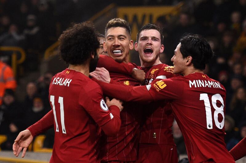 Liverpool's Roberto Firmino (centre, left) celebrates after scoring the second goal against Wolves at the Molineux Stadium. AFP