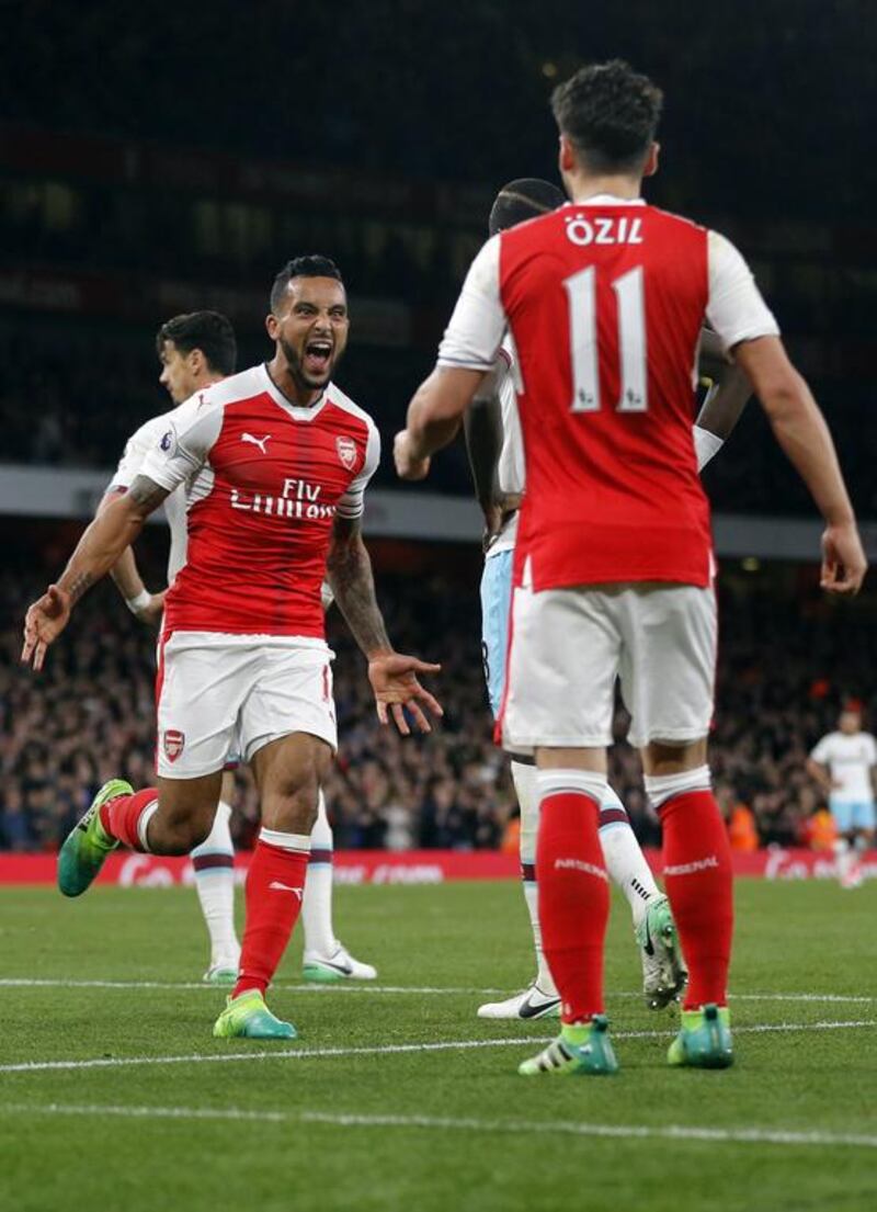 Arsenal's Theo Walcott, left, celebrates his goal against West Ham with Mesut Ozil. Arsenal won 3-0. Frank Augstein / AP