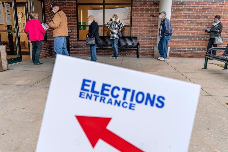 Voters line up as the doors open to the Election Center for absentee early voting for the general election in Sterling Heights, Michigan. AP Photo