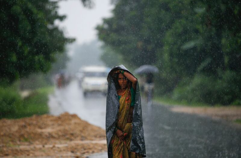 A woman walks under a heavy rainfall at Topa village in Saptari district, Nepal. Narendra Shrestha / EPA