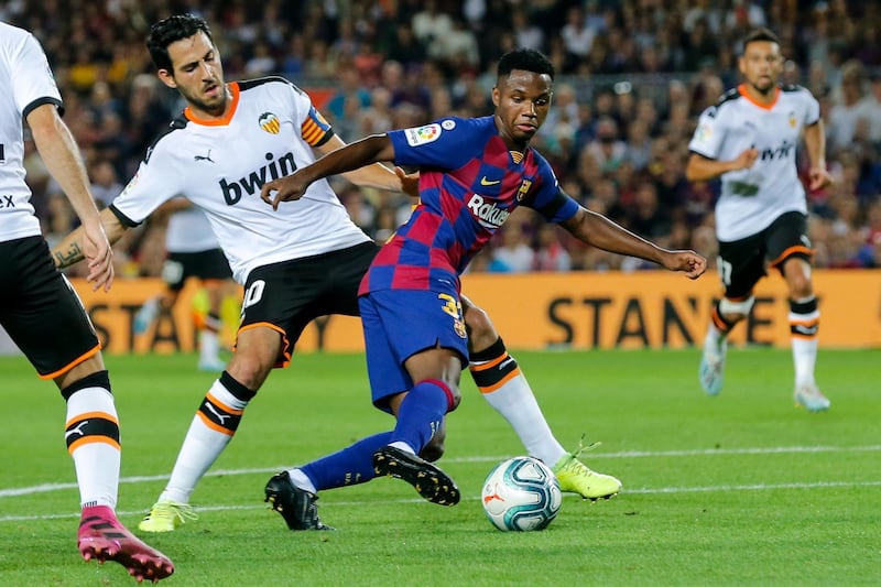 Barcelona´s Guinea-Bissau forward Ansu Fati vies with Valencia's Spanish midfielder Daniel Parejo. AFP