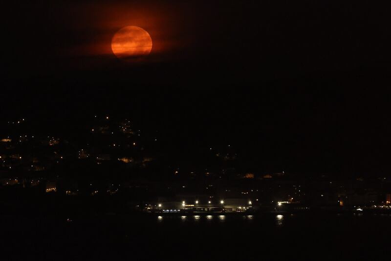 The last full moon of the year behind light cloud in Vigo, north-west Spain. EPA