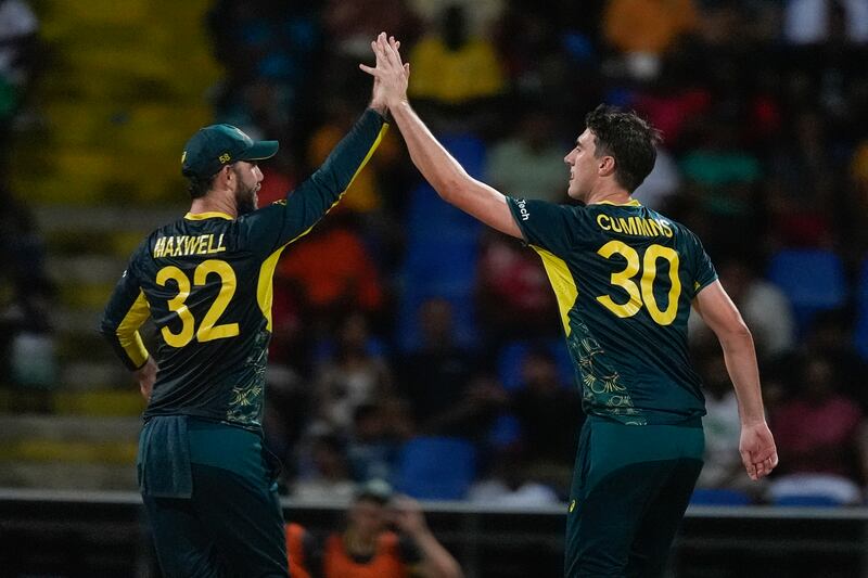 Australia's Pat Cummins, right, is congratulated by teammate Glenn Maxwell after taking the wicket of Bangladesh's Mahmudullah. AP