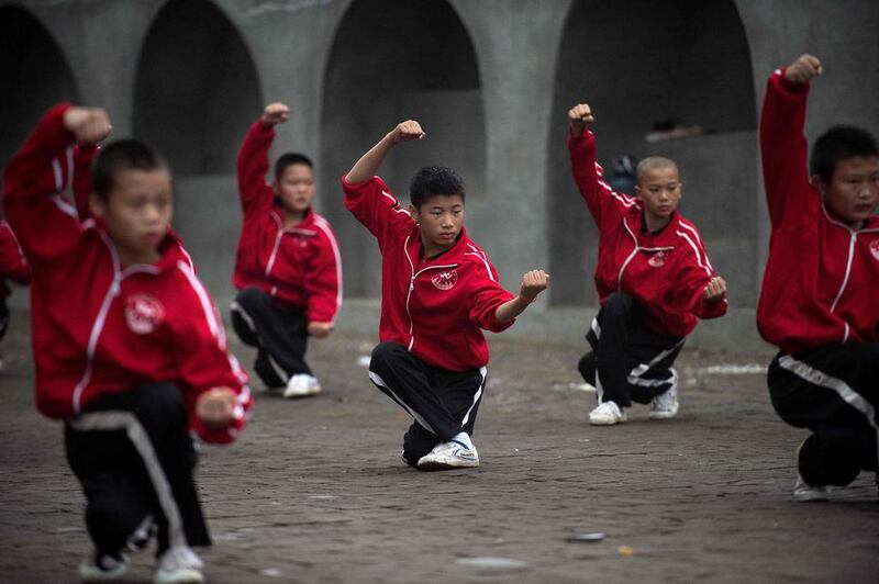 Students practising wushu at the Tagou martial arts school in Dengfeng. China is investing hugely in football training and has vowed to have 50 million school-age players by 2020, as the ruling Communist party eyes "football superpower" status by 2050. Nicolas Asfouri/AFP