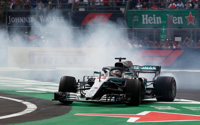 Lewis Hamilton burns rubber to celebrate after his championship triumph. AP Photo