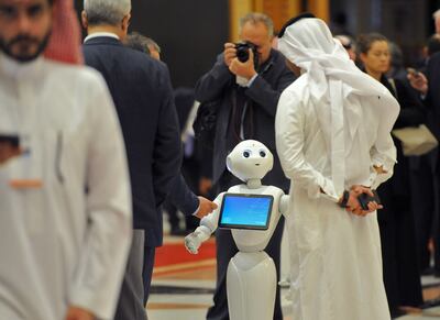 A Saudi man chats with a robot on the sidelines of the three-day Future Investment Initiatives conference in Riyadh, on October 25, 2017. 
Saudi Arabia, smarting from a years-long oil crunch, said it aims to nearly double the assets of its Public Investment Fund by 2020 through launching a programme of investment initiatives.  / AFP PHOTO / FAYEZ NURELDINE